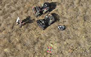 view from a drone in the sky looking down on person, atv, and rangeland